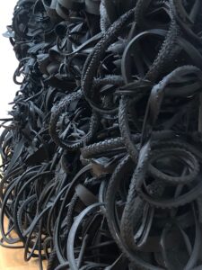 Discarded tires assembled in a vertically mounted to wall, part of a show at the National Gallery, Washington, D.C.