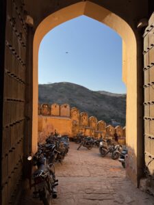 Archway with parked motorbikes at the Amber Fort, Jaipur India.